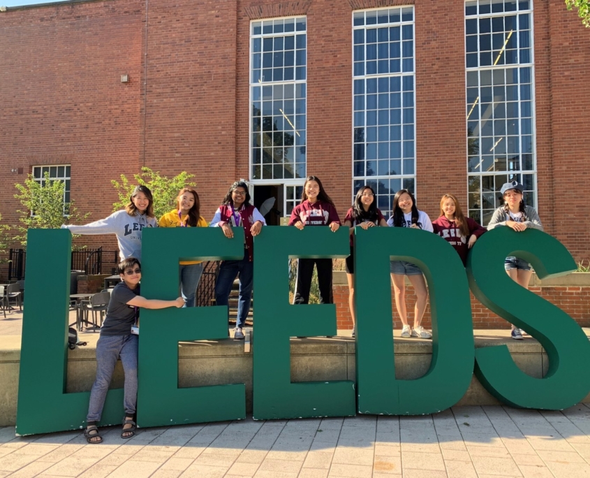 Students stood in front of Leeds sign